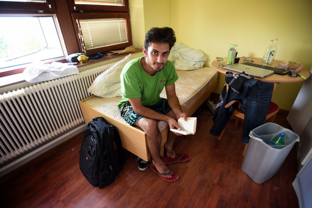 Geflüchteter junger Mann mit seiner neuen Bibel im Pfarrheim der syrisch-orthodoxen Kirche in Wien.